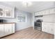 Kitchen with white cabinets and light wood floors at 35209 Ada Ave, Zephyrhills, FL 33541