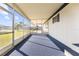 Spacious screened porch with blue carpet flooring at 35209 Ada Ave, Zephyrhills, FL 33541