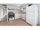 Modern kitchen with stainless steel appliances and wood flooring at 35209 Ada Ave, Zephyrhills, FL 33541
