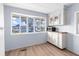 Simple kitchen with white cabinets and a large window at 35209 Ada Ave, Zephyrhills, FL 33541