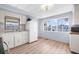Cozy kitchen with white cabinets and a large window at 35209 Ada Ave, Zephyrhills, FL 33541
