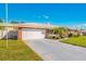 Charming home with a well-manicured lawn, mature landscaping, and an attached two-car garage at 11211 60Th Ave, Seminole, FL 33772