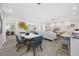 Bright and open-concept living room with dining area featuring new flooring and neutral decor at 11211 60Th Ave, Seminole, FL 33772