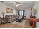 Living room with brown sofa, coffee table, and access to exterior patio at 1150 Orange Tree E Cir # C, Palm Harbor, FL 34684