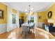 Sunlit dining room with hardwood floors, yellow walls, and a marble dining table at 1726 Serpentine S Dr, St Petersburg, FL 33712