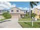 Two-story house with beige siding, gray shutters, and a two-car garage at 1730 Bonita Bluff Ct, Ruskin, FL 33570