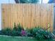 Well-maintained wooden fence with colorful flowerbed at 1751 St Anthony Dr, Clearwater, FL 33759