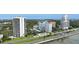An aerial view showcases multiple buildings, a pool, and lush greenery near the waterfront at 2401 Bayshore Blvd # 410 & 510, Tampa, FL 33629