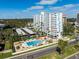 Condominium building with a beautiful pool, parking, and lush landscaping on a sunny day at 2401 Bayshore Blvd # 410 & 510, Tampa, FL 33629