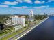 An aerial shot showcases the community's buildings, pool area, and waterfront location at 2401 Bayshore Blvd # 410 & 510, Tampa, FL 33629