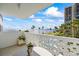 The balcony provides a scenic view of the bay, city skyline, and community pool surrounded by lush foliage at 2401 Bayshore Blvd # 410 & 510, Tampa, FL 33629