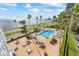 Overhead shot of the community pool and lounge area with tables and chairs surrounded by palm trees at 2401 Bayshore Blvd # 410 & 510, Tampa, FL 33629