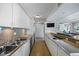Long kitchen with granite countertops and stainless steel appliances at 2401 Bayshore Blvd # 410 & 510, Tampa, FL 33629