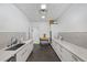 A clean kitchenette featuring white cabinets, a sink, and basic appliances at 2401 Bayshore Blvd # 410 & 510, Tampa, FL 33629