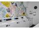 A spacious laundry room showcases several modern washers and a utility sink, decorated with a colorful mural at 2401 Bayshore Blvd # 410 & 510, Tampa, FL 33629