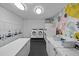 A laundry room equipped with several washing machines and dryers and a folding table at 2401 Bayshore Blvd # 410 & 510, Tampa, FL 33629