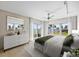 A bright main bedroom featuring a ceiling fan and a view of the water through large sliding glass doors at 2401 Bayshore Blvd # 410 & 510, Tampa, FL 33629