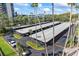 Exterior view of a covered parking area with mature landscaping and yellow parking markers at 2401 Bayshore Blvd # 410 & 510, Tampa, FL 33629