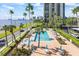 Community pool with lounge chairs and waterfront views at 2401 Bayshore Blvd # 410 & 510, Tampa, FL 33629