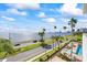 Stunning waterfront view showcasing blue skies and palm trees adjacent to a road near downtown at 2401 Bayshore Blvd # 410 & 510, Tampa, FL 33629
