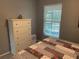 Bright bedroom with a dresser and a window at 2998 Bonaventure Cir # 101, Palm Harbor, FL 34684