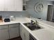 Modern kitchen with stainless steel appliances and gray cabinets at 2998 Bonaventure Cir # 101, Palm Harbor, FL 34684