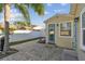 Backyard patio with light gray pavers, a fire pit, and a partially visible white fence at 4129 36Th N Ave, St Petersburg, FL 33713