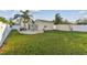Spacious backyard with a fire pit, shed, outdoor grill, and ample lawn space, perfect for entertaining at 4129 36Th N Ave, St Petersburg, FL 33713