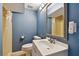 Compact bathroom featuring a vanity with a mirror, toilet, and a shower with a yellow tile surround at 4129 36Th N Ave, St Petersburg, FL 33713