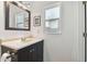 Simple bathroom with dark vanity and large mirror at 4129 36Th N Ave, St Petersburg, FL 33713