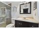 Clean bathroom with dark vanity and walk-in shower at 4129 36Th N Ave, St Petersburg, FL 33713