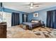 Spacious bedroom with king-size bed, built-in bench, and ceiling fan at 4129 36Th N Ave, St Petersburg, FL 33713