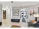 Open living room with neutral tones, tile flooring, and a decorative wall hanging at 4129 36Th N Ave, St Petersburg, FL 33713
