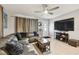 Spacious living room with a ceiling fan, a large TV, and tile flooring at 4129 36Th N Ave, St Petersburg, FL 33713