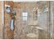 Modern shower with neutral tile, glass doors, and shampoo storage at 4129 36Th N Ave, St Petersburg, FL 33713