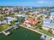 Aerial view of waterfront home with pool and private dock at 425 Capri Blvd, Treasure Island, FL 33706