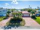 House exterior features brick driveway and waterfront view at 425 Capri Blvd, Treasure Island, FL 33706