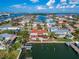 Aerial view of a waterfront home with a private pool and dock at 425 Capri Blvd, Treasure Island, FL 33706