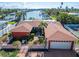 Waterfront home with red roof and two-car garage at 425 Capri Blvd, Treasure Island, FL 33706