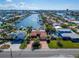 Aerial view of waterfront home with private driveway and canal access at 425 Capri Blvd, Treasure Island, FL 33706