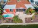 An aerial view showcasing a single-story home, pool, and backyard at 425 Capri Blvd, Treasure Island, FL 33706