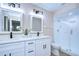 Elegant bathroom with white double vanity, quartz countertops, and frameless shower at 4608 Glenside Cir, Tampa, FL 33624