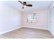 Simple bedroom with large window, ceiling fan, and light neutral walls at 4608 Glenside Cir, Tampa, FL 33624