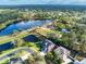 Aerial view of house near lake with community background at 511 Crowned Eagle Ct, Valrico, FL 33594