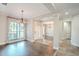 Elegant dining room with hardwood floors, chandelier, and large windows at 511 Crowned Eagle Ct, Valrico, FL 33594