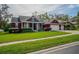 Beautiful red house with a large front yard, two-car garage, and well-manicured lawn at 511 Crowned Eagle Ct, Valrico, FL 33594