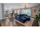 Comfortable Gathering room with dark hardwood floors, sectional sofa and large windows at 511 Crowned Eagle Ct, Valrico, FL 33594