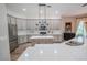 Modern kitchen with white cabinets, quartz countertops, and a large island at 511 Crowned Eagle Ct, Valrico, FL 33594