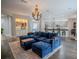 Spacious living room featuring a large sectional sofa and a stunning chandelier at 511 Crowned Eagle Ct, Valrico, FL 33594