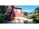 Brick paved patio with landscaping and a red exterior wall at 511 Crowned Eagle Ct, Valrico, FL 33594